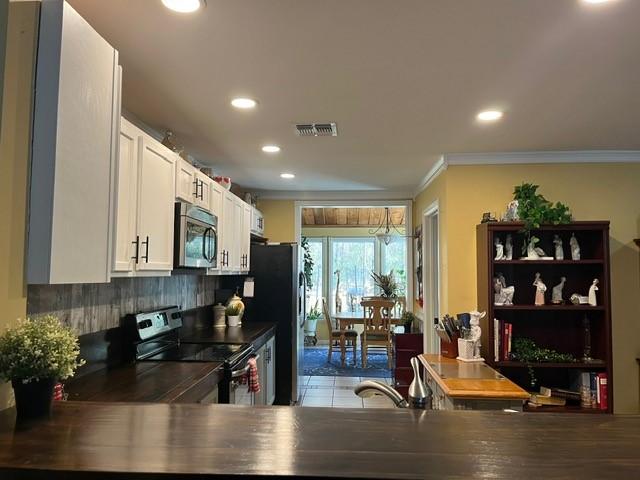 kitchen with visible vents, recessed lighting, white cabinetry, and appliances with stainless steel finishes