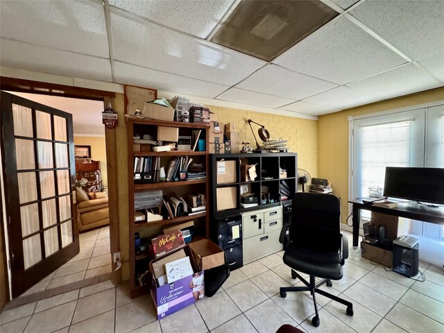 tiled office space featuring a drop ceiling