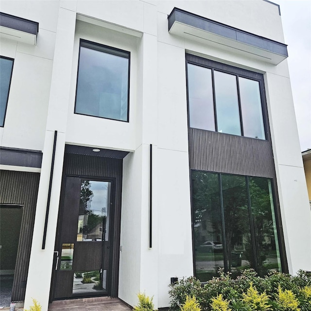 doorway to property with stucco siding