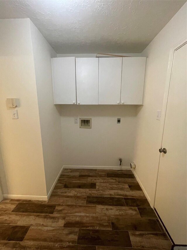laundry area with cabinet space, hookup for a washing machine, a textured ceiling, dark wood finished floors, and electric dryer hookup