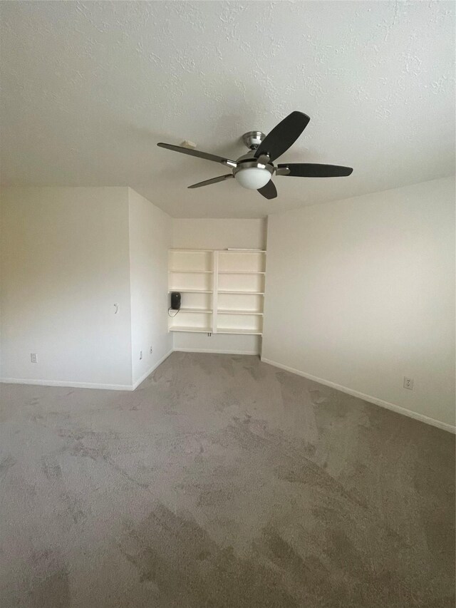 spare room with baseboards, carpet flooring, a textured ceiling, and ceiling fan