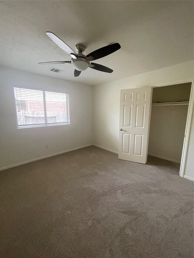 unfurnished bedroom with baseboards, carpet flooring, and visible vents