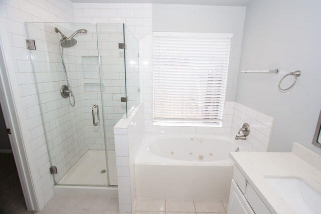 bathroom featuring vanity, tile patterned flooring, a shower stall, and a tub with jets