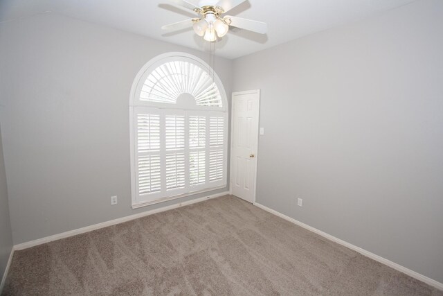 spare room with baseboards, a ceiling fan, and carpet flooring