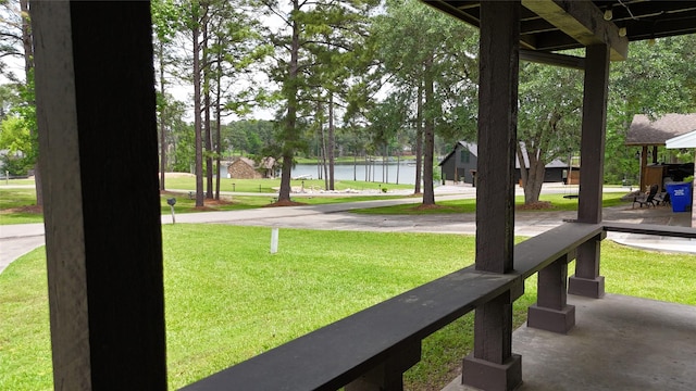 view of home's community with a yard and a water view