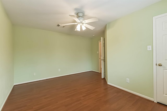 unfurnished room featuring baseboards, ceiling fan, wood finished floors, and visible vents