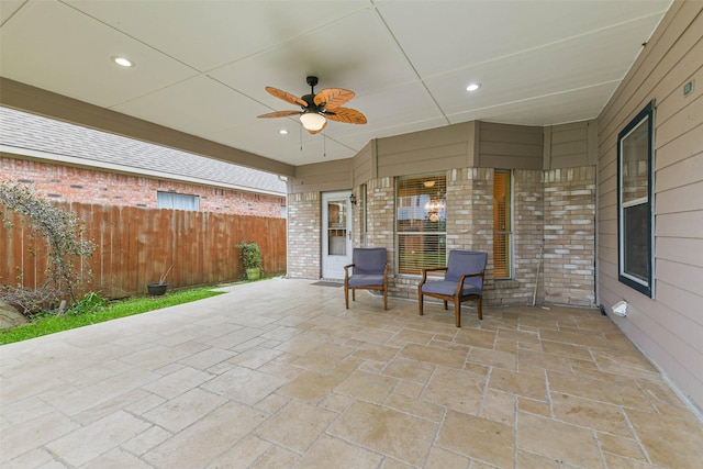 view of patio / terrace with fence and a ceiling fan