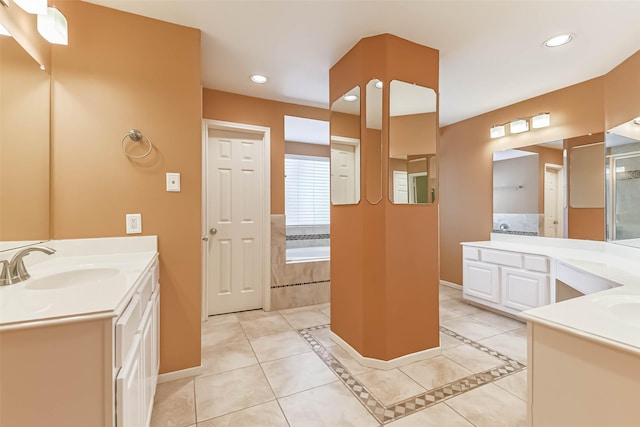 full bath with baseboards, a sink, a bath, and two vanities