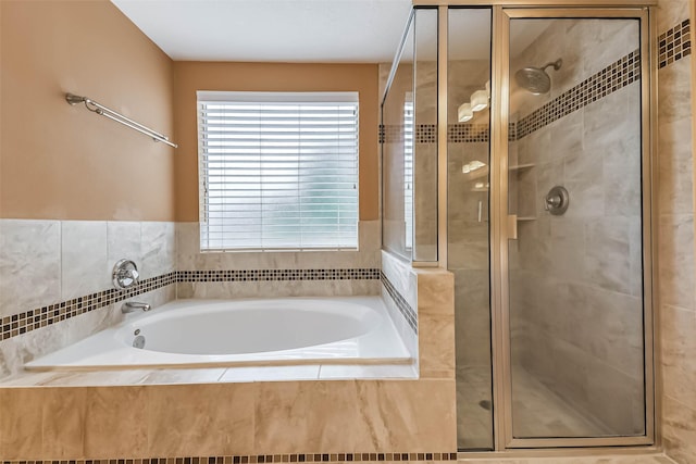 full bathroom with a stall shower and a bath