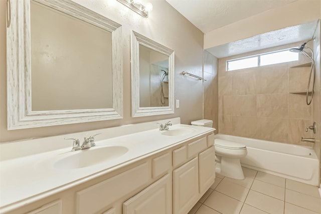 full bathroom featuring double vanity, toilet, tile patterned floors, and a sink