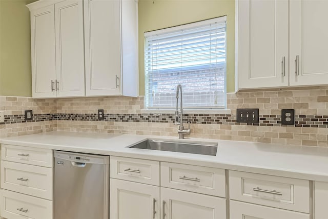 kitchen featuring stainless steel dishwasher, a sink, tasteful backsplash, and light countertops