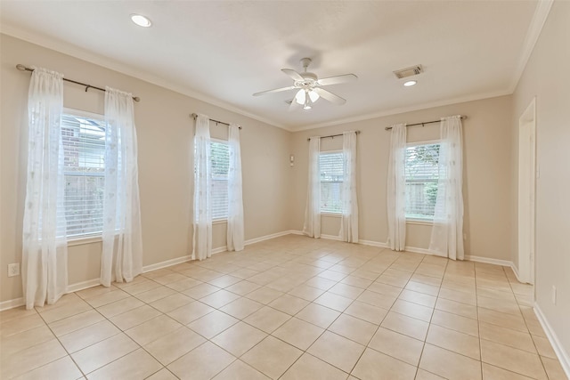 empty room with visible vents, ornamental molding, baseboards, a ceiling fan, and light tile patterned floors