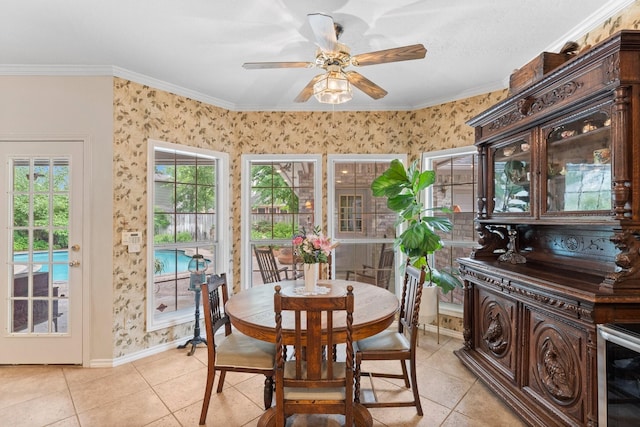 dining space with light tile patterned floors, baseboards, ornamental molding, and a ceiling fan