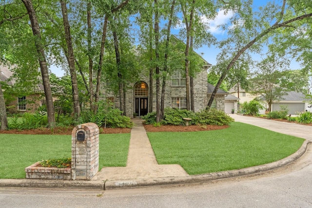 view of front of property featuring a front lawn and stone siding