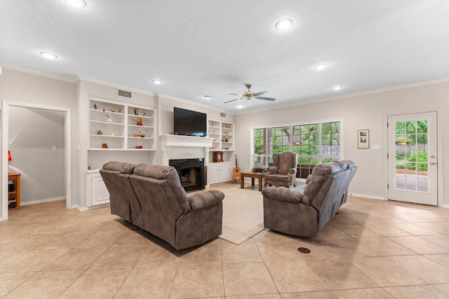 living area with crown molding, visible vents, a fireplace, recessed lighting, and a ceiling fan