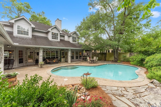 view of swimming pool with a patio, fence, french doors, and a fenced in pool