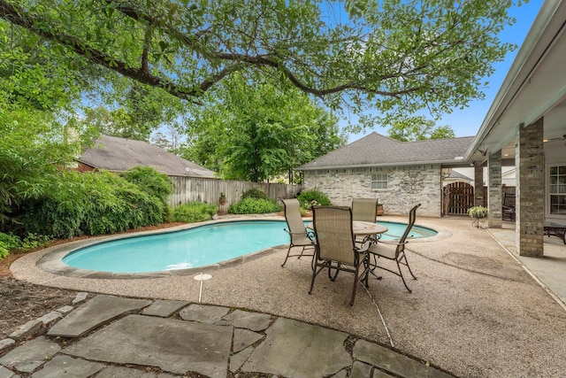view of swimming pool with a fenced in pool, a fenced backyard, and a patio area