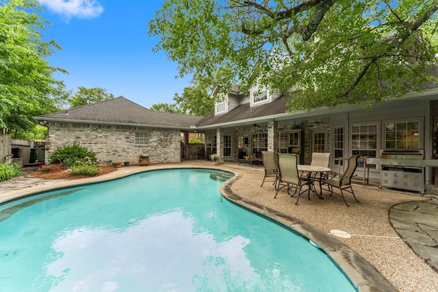 pool featuring a patio, ceiling fan, and fence