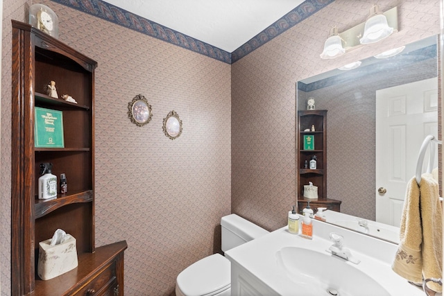 bathroom featuring toilet and vanity