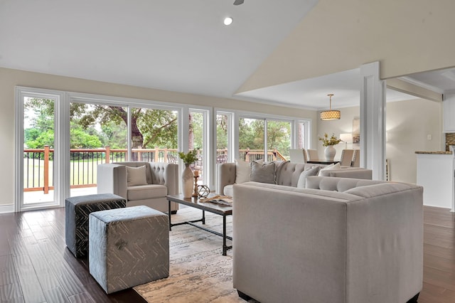 living area with vaulted ceiling, crown molding, recessed lighting, and wood finished floors