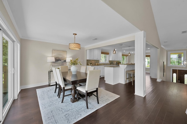 dining area featuring dark wood finished floors, visible vents, baseboards, and a healthy amount of sunlight