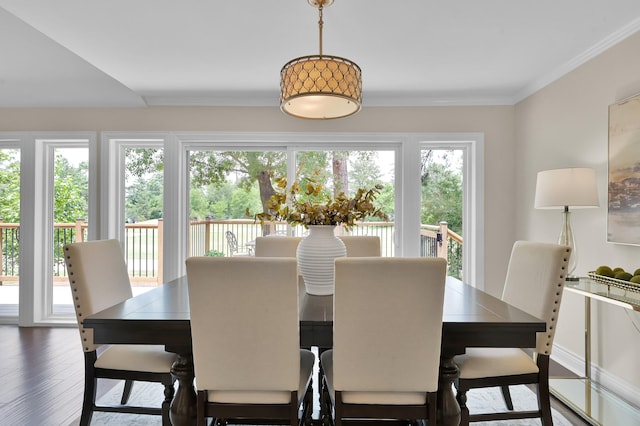 dining space featuring ornamental molding and wood finished floors