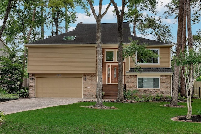 raised ranch featuring concrete driveway, an attached garage, brick siding, and a front yard