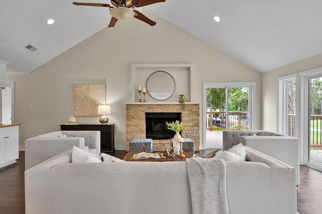 living room featuring ceiling fan, visible vents, dark wood-style floors, and high vaulted ceiling