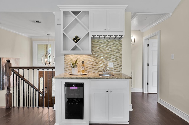 bar with wine cooler, dark wood-style flooring, visible vents, a sink, and indoor wet bar