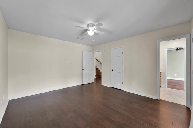 unfurnished bedroom with visible vents, baseboards, and dark wood-style floors