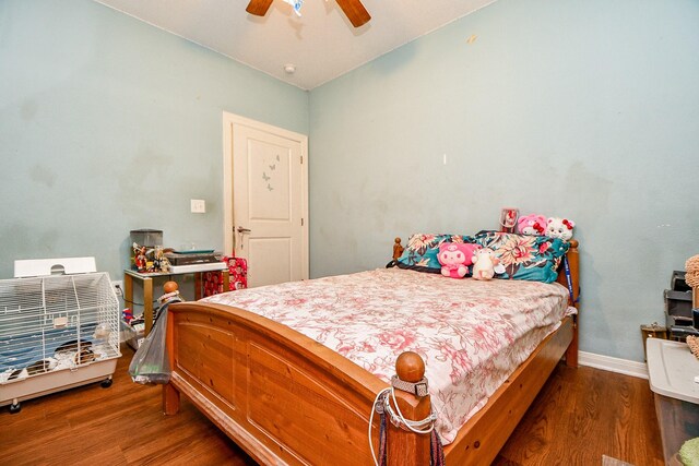 bedroom with baseboards, a ceiling fan, and wood finished floors