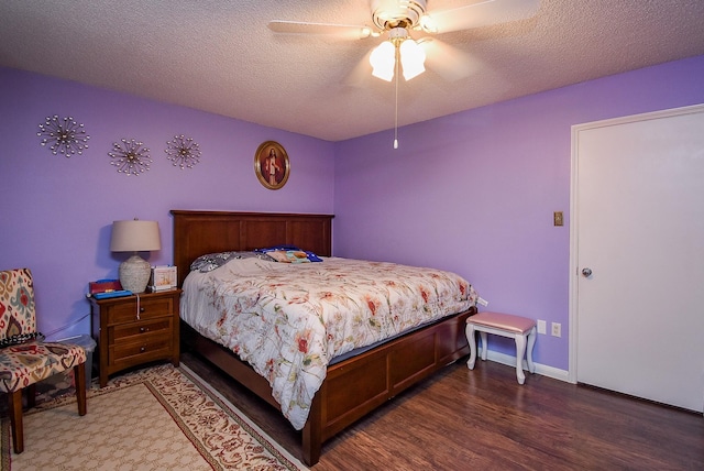 bedroom with a textured ceiling, ceiling fan, and wood finished floors