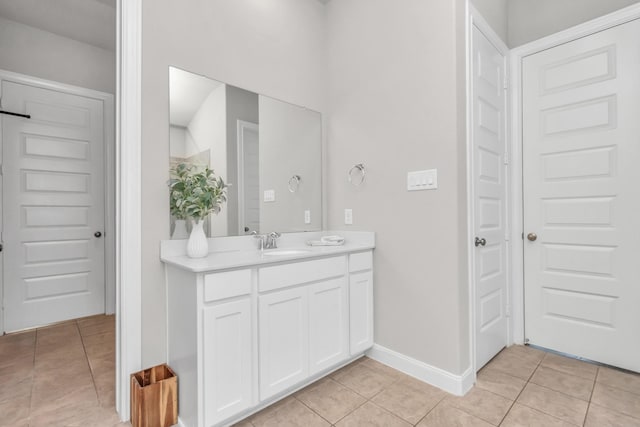 full bathroom featuring vanity, tile patterned flooring, and baseboards