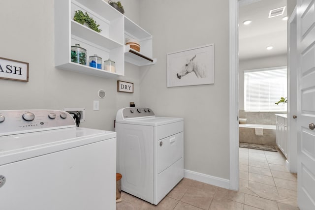 laundry room featuring independent washer and dryer, laundry area, baseboards, light tile patterned floors, and visible vents