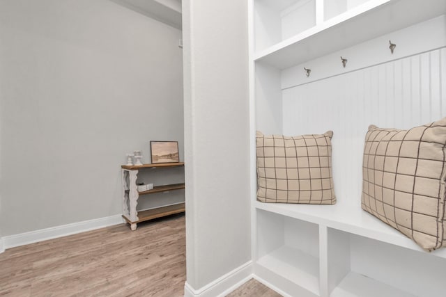 mudroom with baseboards and wood finished floors