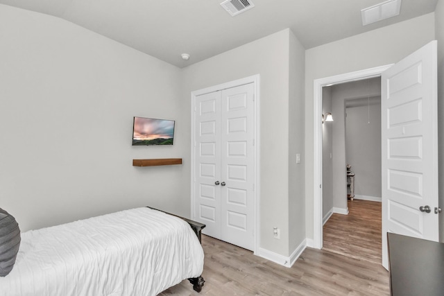 bedroom featuring visible vents, baseboards, and wood finished floors