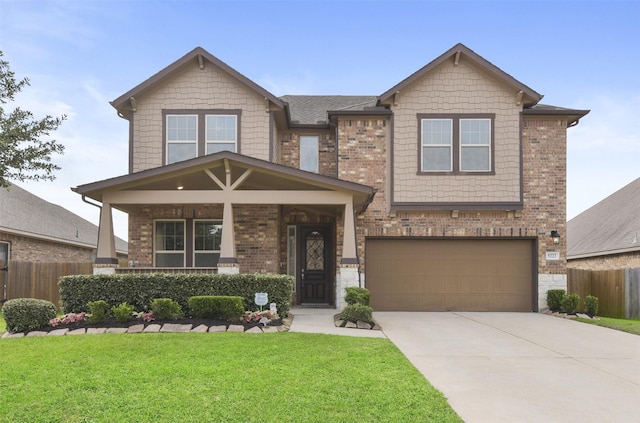 craftsman inspired home featuring concrete driveway, an attached garage, fence, and a front yard