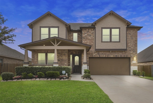 craftsman inspired home featuring a garage, fence, a front yard, brick siding, and concrete driveway
