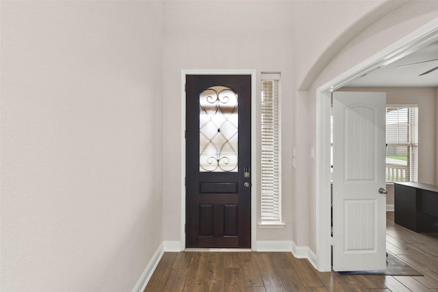 foyer entrance with baseboards and dark wood-style floors