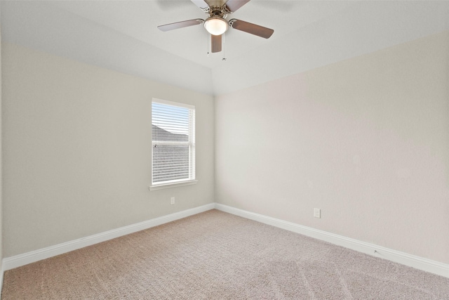 carpeted empty room featuring baseboards and a ceiling fan