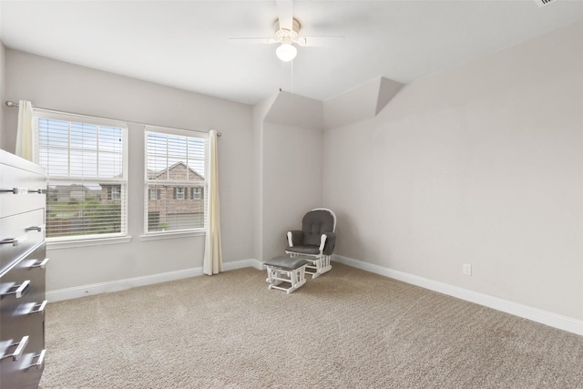 unfurnished room featuring carpet flooring, a ceiling fan, baseboards, and lofted ceiling