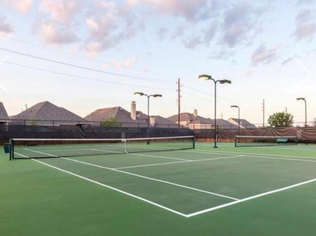 view of tennis court with fence