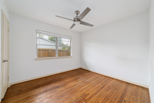 empty room featuring baseboards, ceiling fan, and hardwood / wood-style floors