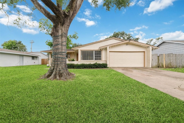 single story home featuring fence, an attached garage, driveway, and a front lawn