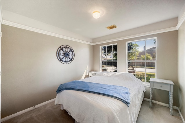 carpeted bedroom with baseboards and visible vents