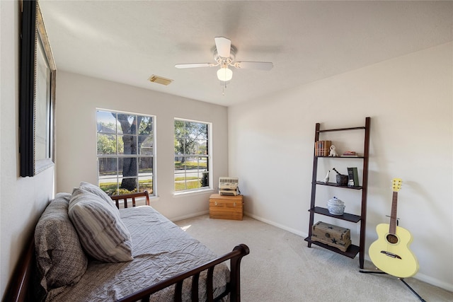 bedroom featuring baseboards, ceiling fan, light colored carpet, and visible vents