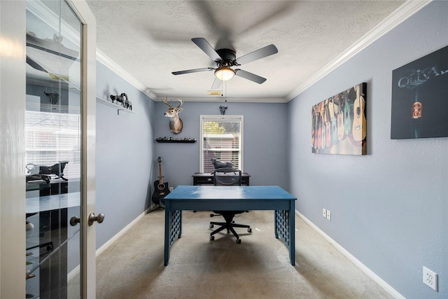 carpeted office with crown molding, a ceiling fan, a textured ceiling, and baseboards