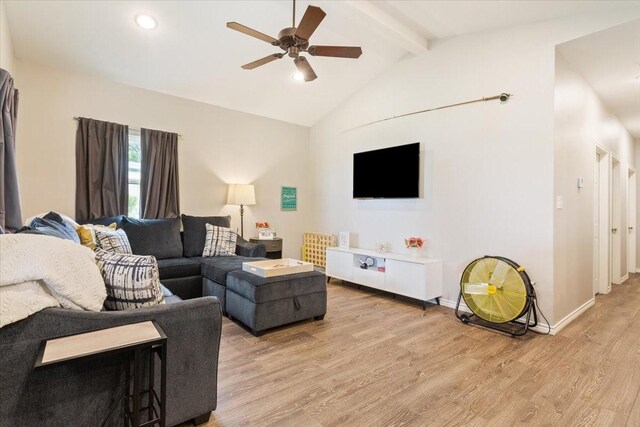living room with ceiling fan, beam ceiling, light wood finished floors, high vaulted ceiling, and baseboards