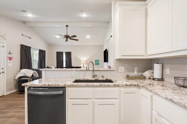 kitchen featuring ceiling fan, a sink, vaulted ceiling with beams, stainless steel dishwasher, and visible vents