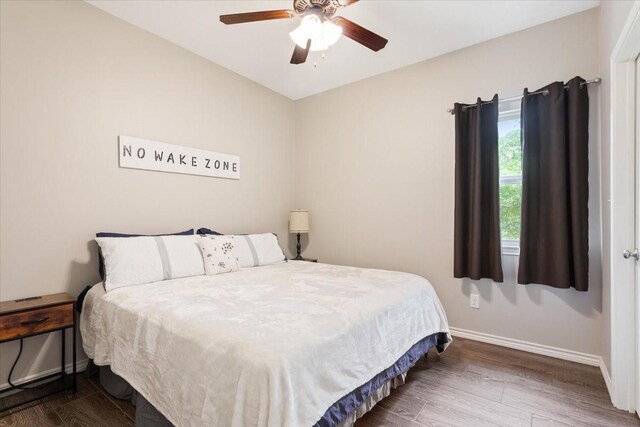 bedroom featuring baseboards, ceiling fan, and wood finished floors